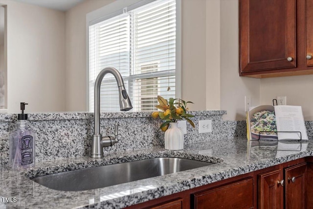 kitchen with sink and light stone counters