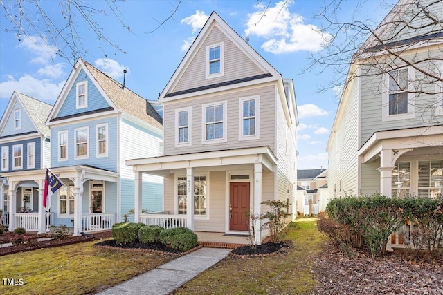 view of front of property featuring covered porch and a front yard