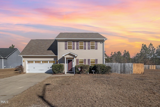 view of front facade with a yard and a garage