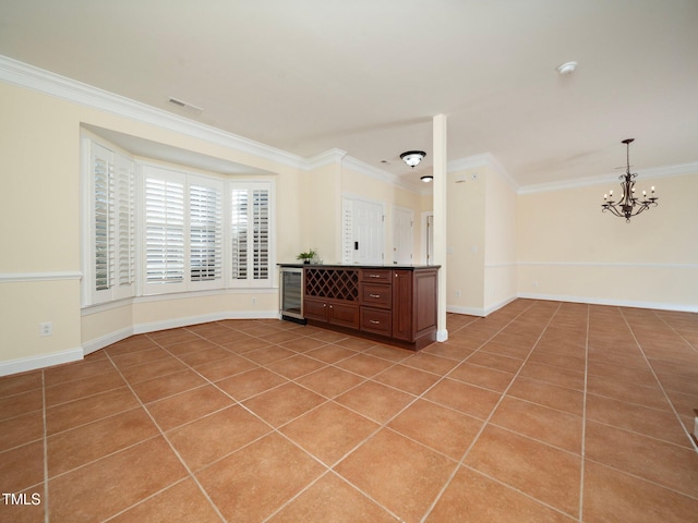 tiled empty room with crown molding, beverage cooler, and a notable chandelier