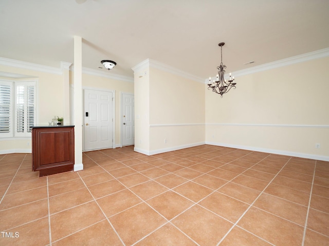 tiled empty room featuring an inviting chandelier and crown molding