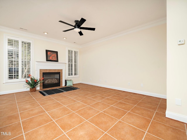 unfurnished living room featuring ceiling fan, ornamental molding, tile patterned floors, and a fireplace