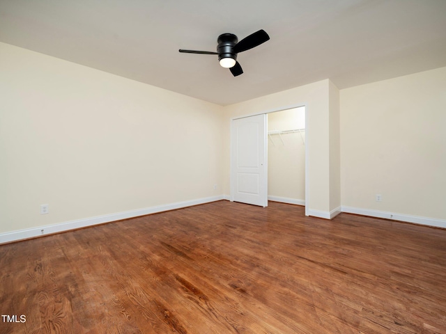 unfurnished bedroom with hardwood / wood-style floors, ceiling fan, and a closet