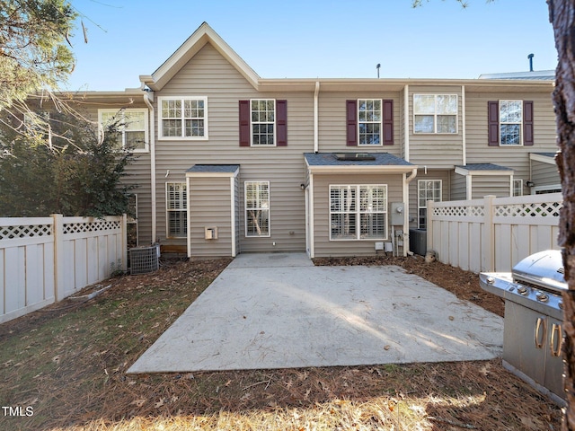 rear view of house featuring a patio and central AC