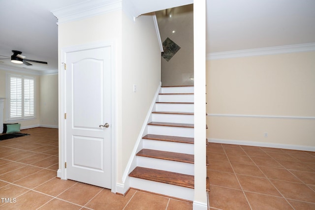 stairs featuring ceiling fan, ornamental molding, and tile patterned flooring