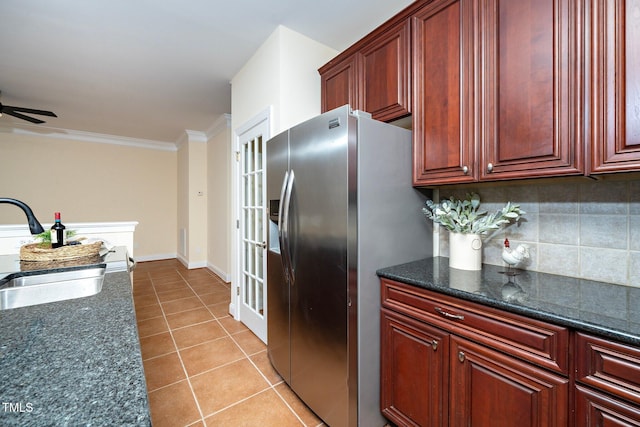 kitchen with stainless steel refrigerator with ice dispenser, light tile patterned flooring, sink, ornamental molding, and decorative backsplash