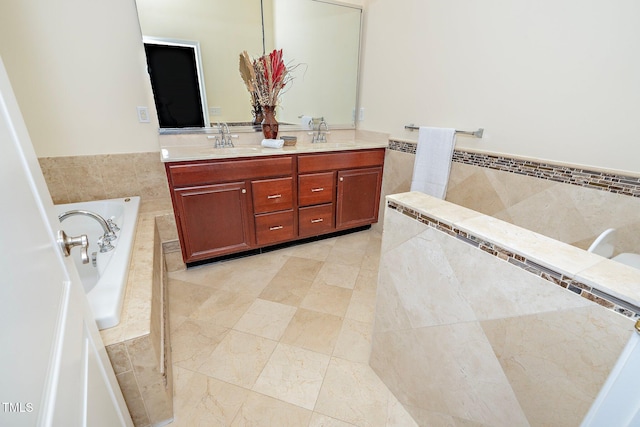 bathroom with vanity and tiled tub