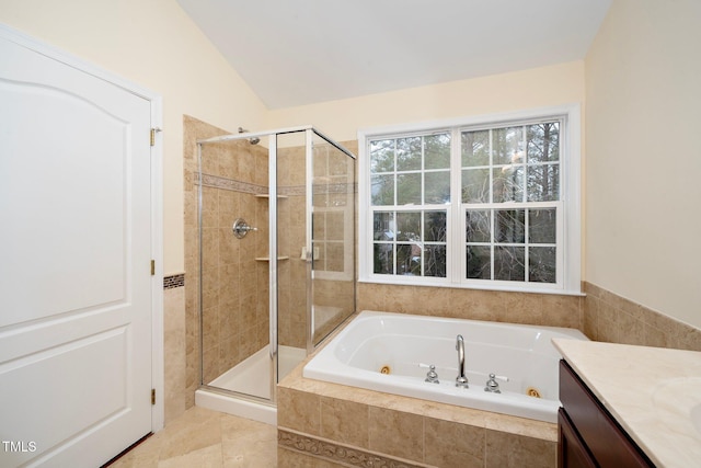 bathroom featuring tile patterned flooring, vanity, vaulted ceiling, and independent shower and bath