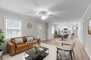 living room featuring ornamental molding, light wood-type flooring, and ceiling fan