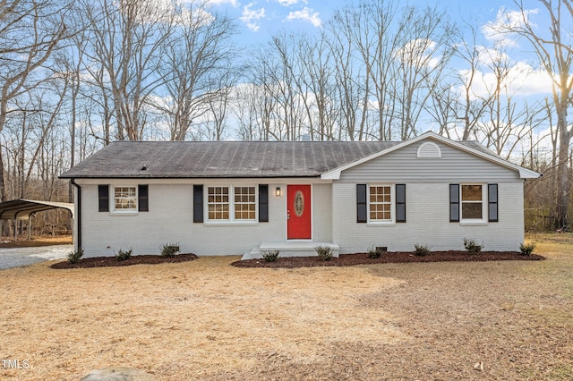 single story home with a front lawn and a carport