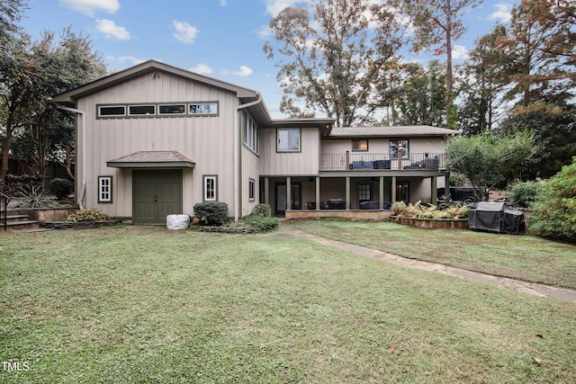 rear view of property featuring a lawn