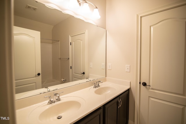 bathroom featuring double vanity, visible vents, and a sink