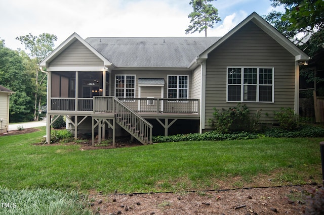 back of house featuring stairway, roof with shingles, a yard, and a sunroom