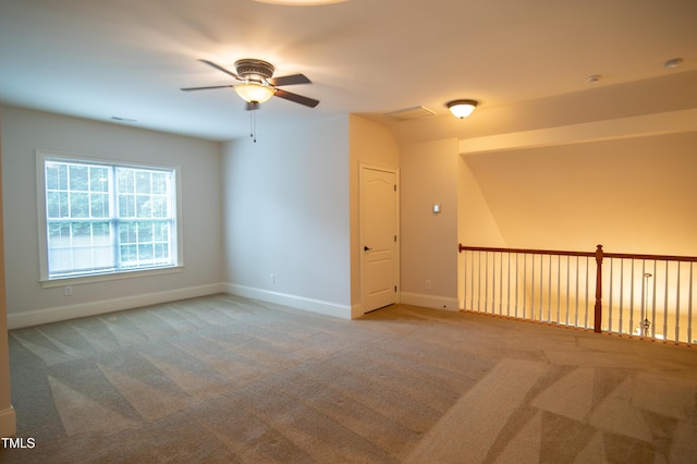 empty room with baseboards, carpet floors, and visible vents