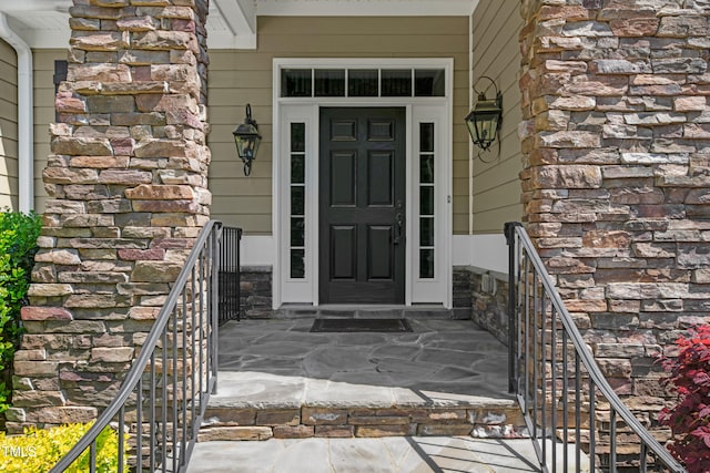 property entrance featuring stone siding