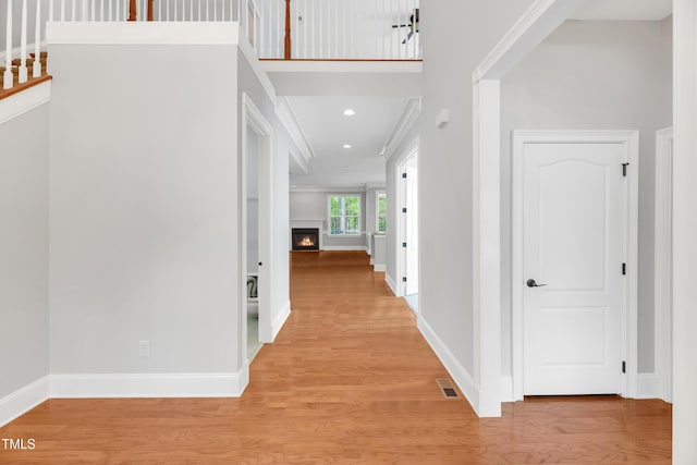 corridor with visible vents, baseboards, light wood-type flooring, and recessed lighting