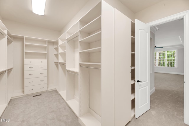 walk in closet with light carpet and visible vents