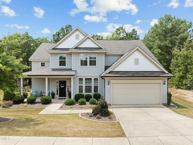 view of front of house with a garage, a porch, and a front yard