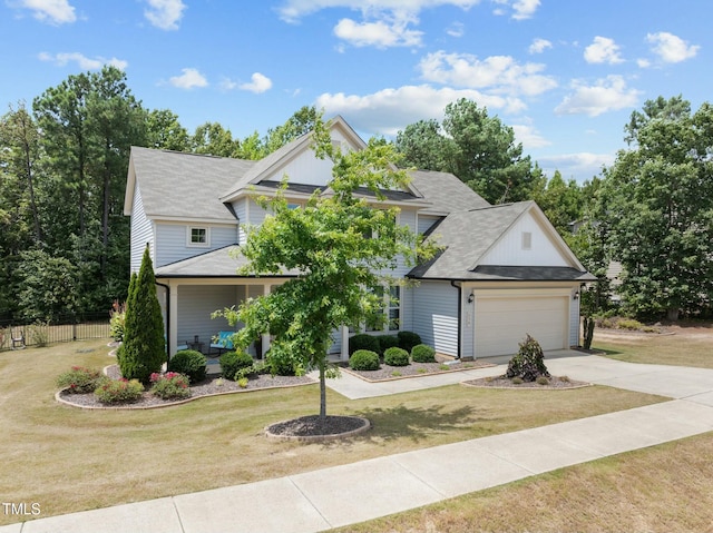 view of front of property featuring a garage and a front lawn