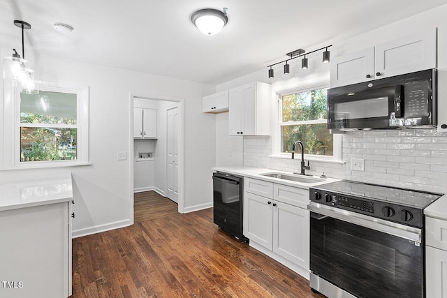 kitchen featuring dark hardwood / wood-style flooring, sink, black appliances, white cabinets, and hanging light fixtures