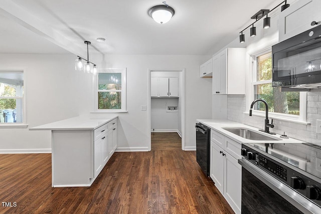 kitchen with black appliances, white cabinets, sink, tasteful backsplash, and decorative light fixtures