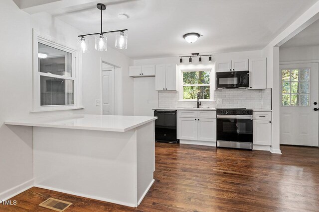 kitchen featuring black appliances, kitchen peninsula, decorative backsplash, decorative light fixtures, and white cabinetry