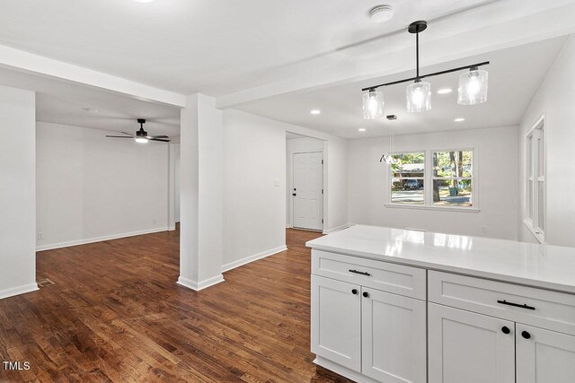 kitchen featuring white cabinetry, ceiling fan, dark hardwood / wood-style floors, and decorative light fixtures