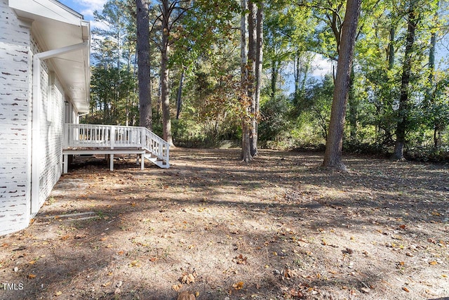 view of yard featuring a wooden deck