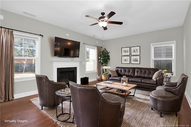 110 Pinecrest Dr, Fayetteville, NC 28305 - living room featuring a ceiling fan, a glass covered fireplace, baseboards, visible vents, and dark wood-style flooring