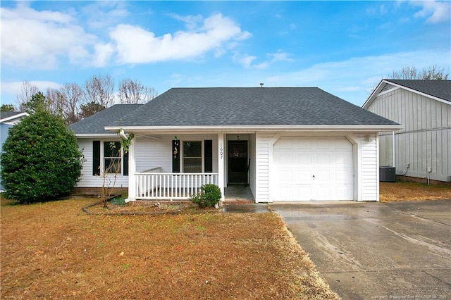 ranch-style house featuring a porch, a garage, and central air condition unit