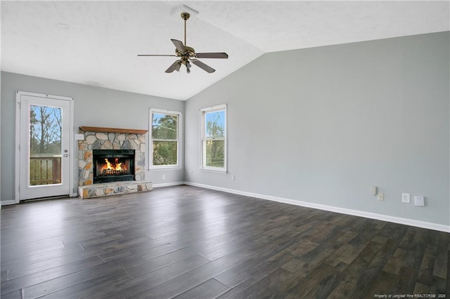 unfurnished living room with ceiling fan, a fireplace, lofted ceiling, and dark wood-type flooring