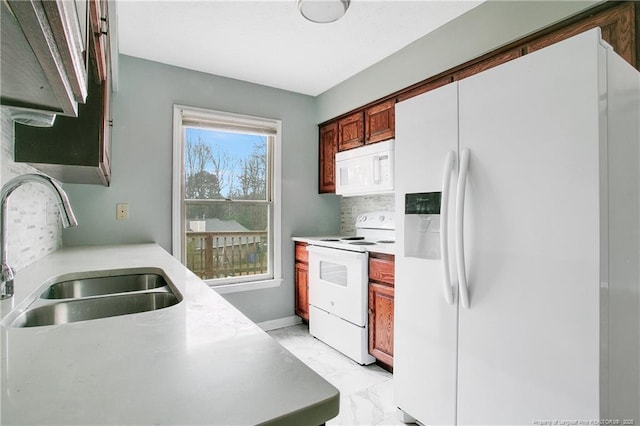 kitchen featuring decorative backsplash, white appliances, and sink