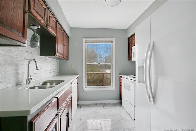 kitchen with backsplash, white appliances, and sink