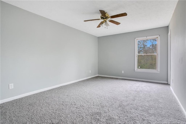 empty room featuring carpet and ceiling fan