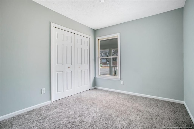 unfurnished bedroom with carpet floors and a closet