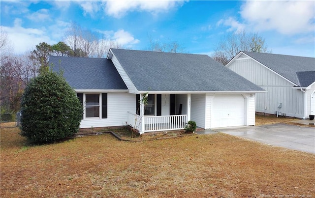 view of front of home featuring a front lawn, covered porch, and a garage