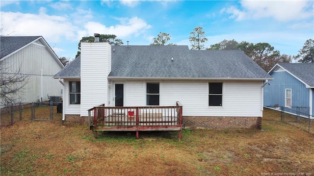 back of house with a yard and a deck