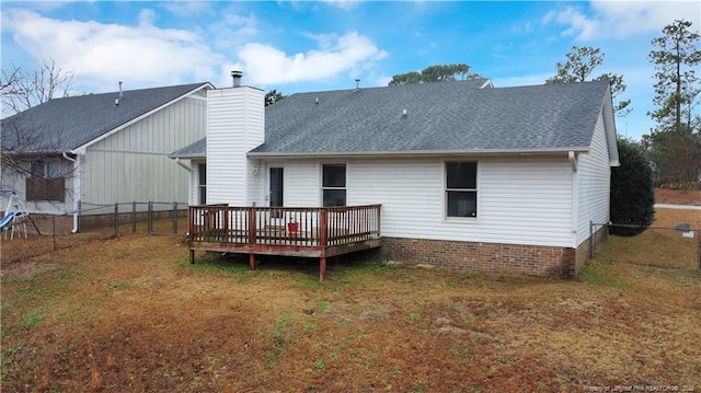 back of property featuring a yard and a wooden deck