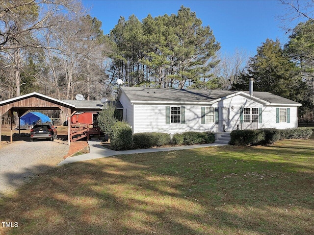 view of front of property featuring a front yard and a carport