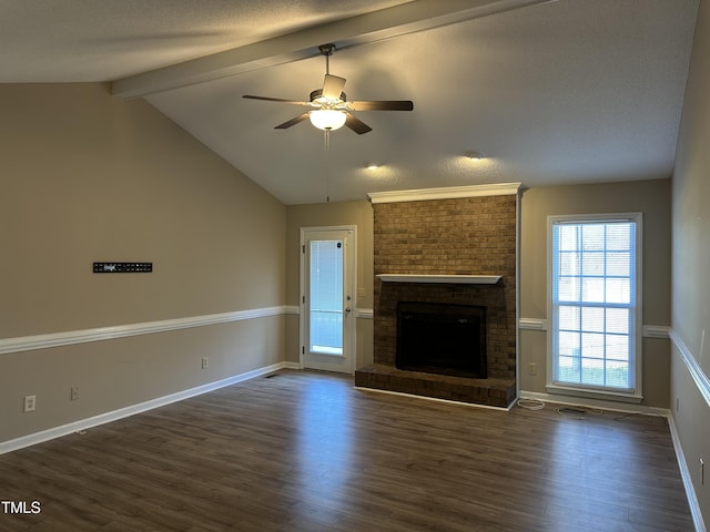 unfurnished living room featuring lofted ceiling with beams, ceiling fan, dark hardwood / wood-style flooring, and a fireplace