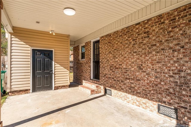 view of exterior entry with a porch