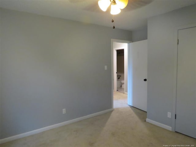 unfurnished room featuring ceiling fan and light colored carpet