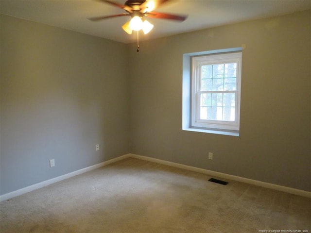 empty room featuring light carpet and ceiling fan