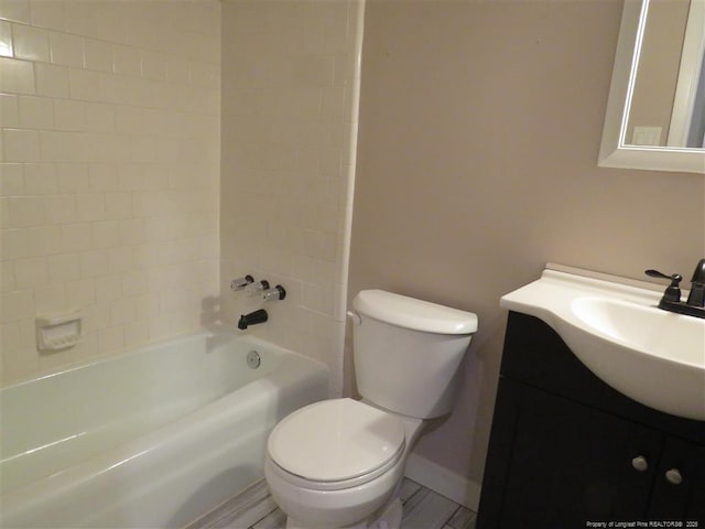 full bathroom featuring vanity, toilet, and tiled shower / bath combo