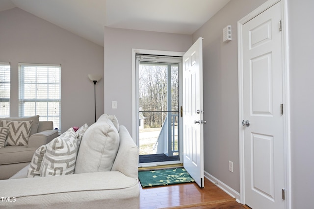 interior space with vaulted ceiling, a healthy amount of sunlight, and hardwood / wood-style floors