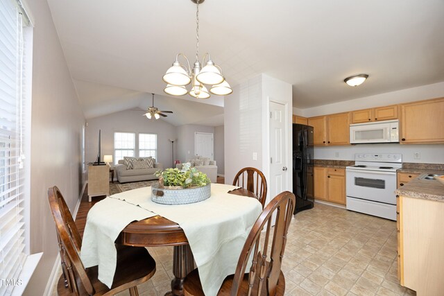 dining area with ceiling fan with notable chandelier and lofted ceiling