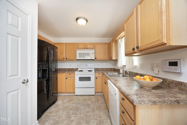 kitchen with sink, white appliances, and light brown cabinetry