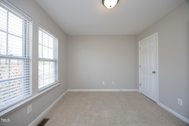 unfurnished room with light colored carpet