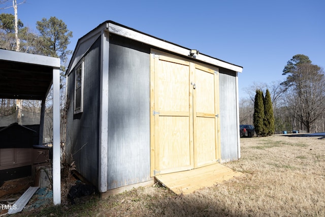 view of outbuilding with a lawn