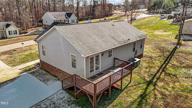 exterior space with french doors, central AC, a deck, and a lawn